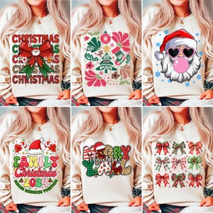 May include: Six different Christmas themed sweatshirts with various designs. The sweatshirts are all cream colored with long sleeves and a crew neck. The designs include a Santa Claus with sunglasses, a Christmas tree with ornaments, a family Christmas design, a Merry Christmas design, and a bow design.