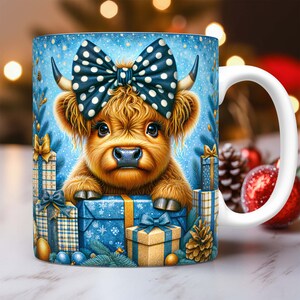 May include: A white ceramic mug with a blue background featuring a Highland cow wearing a blue and white polka dot bow. The cow is surrounded by Christmas presents and greenery.