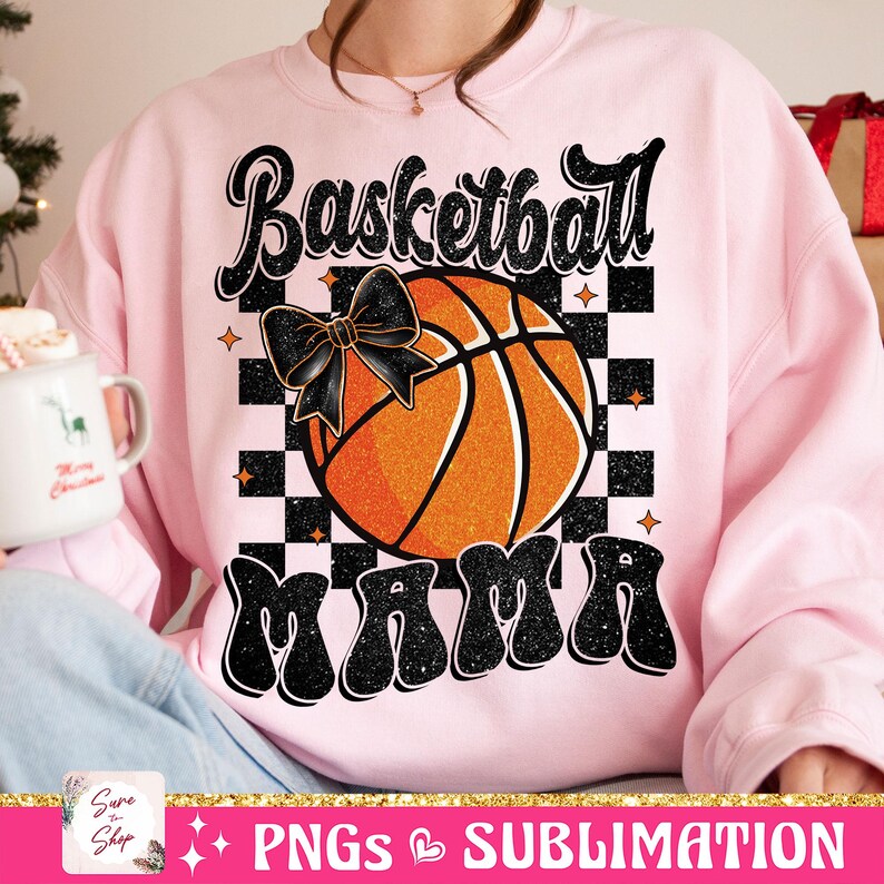 May include: Pink sweatshirt with a black and orange basketball graphic and the text "Basketball Mama" in black glitter letters.