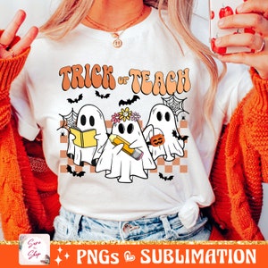 May include: White t-shirt with the text "Trick or Teach" in orange and brown letters. Three ghosts are depicted, one holding a book, one holding a pencil, and one holding a pumpkin.