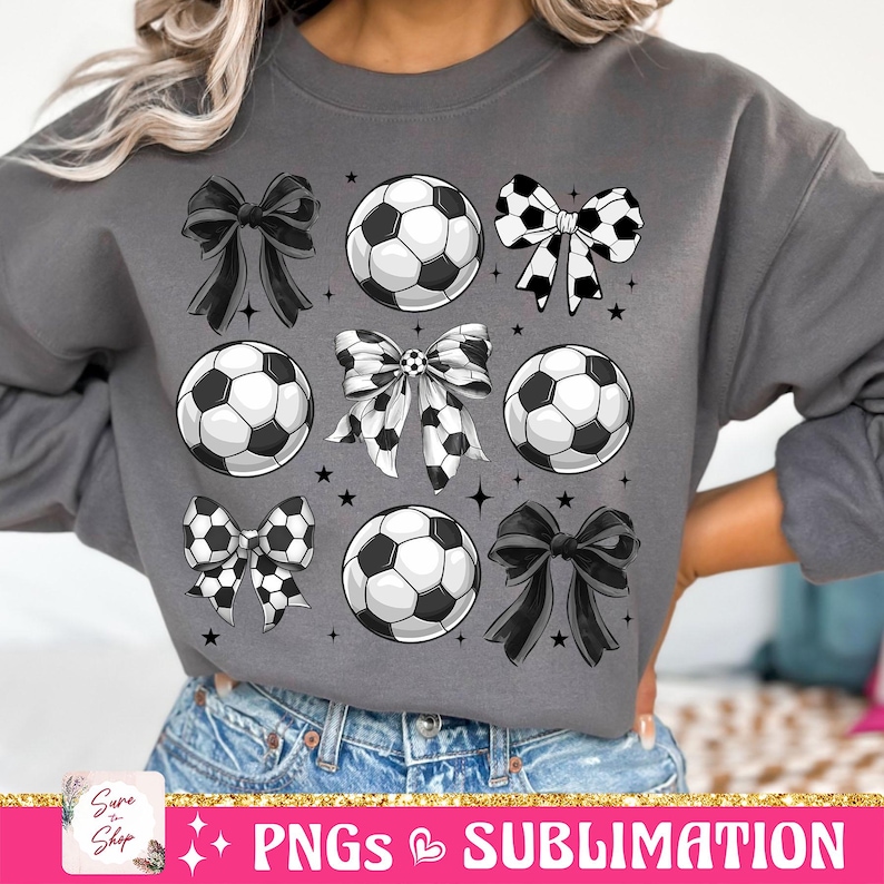 May include: A grey sweatshirt with a sublimation design of black and white footballs and bows. The design is repeated throughout the sweatshirt.