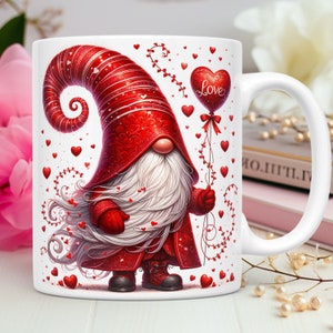 May include: White ceramic mug featuring a Valentine's Day gnome with a long white beard and a red hat and coat. The gnome holds a heart-shaped balloon that says "Love". Red hearts are scattered around the gnome.