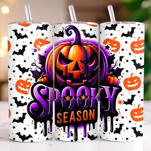 May include: A white tumbler with a purple and orange Halloween design. The design features a pumpkin with a spooky face, bats, stars, and the text "Spooky Season".