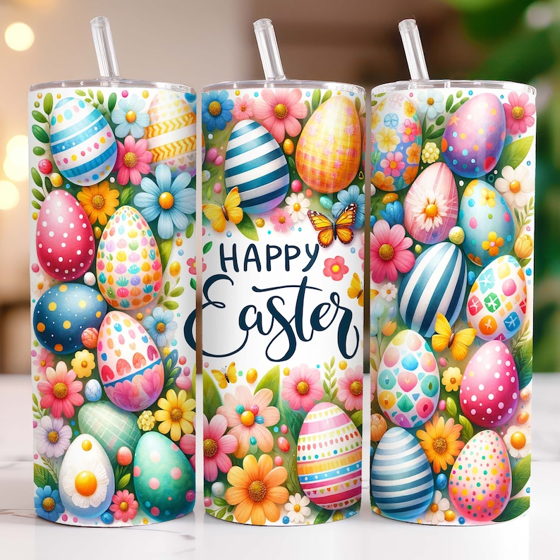 May include: A white tumbler with a colourful Easter egg design. The tumbler features a variety of brightly coloured eggs with different patterns, surrounded by pink, yellow and green flowers. The text "Happy Easter" is written in a white cursive font on the tumbler.