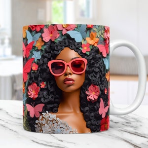 May include: White ceramic mug with a colorful design featuring a woman with black curly hair wearing pink sunglasses and surrounded by pink, red, and blue flowers and butterflies.