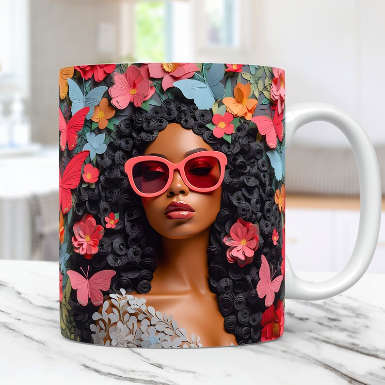 May include: White ceramic mug with a colorful design featuring a woman with black curly hair wearing pink sunglasses and surrounded by pink, red, and blue flowers and butterflies.
