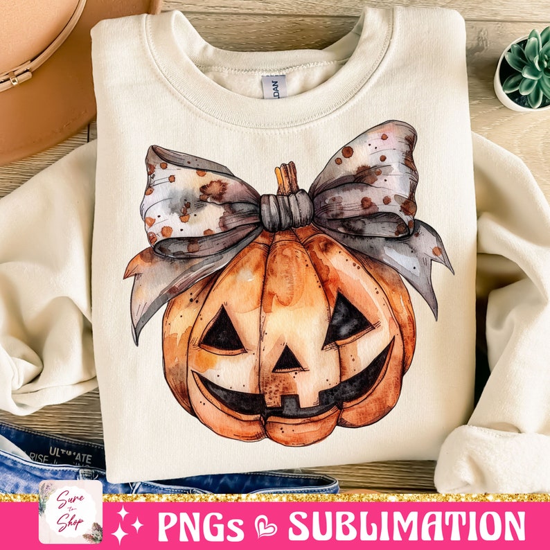 May include: A watercolor illustration of a pumpkin with a bow on top. The pumpkin is orange and has a carved jack-o'-lantern face. The bow is brown and white with a speckled pattern.