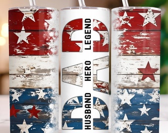 May include: Three stainless steel tumblers with lids and straws. The tumblers feature a distressed American flag design with red, white, and blue colors. The middle tumbler has the words "Husband Hero Legend" printed on it in black.