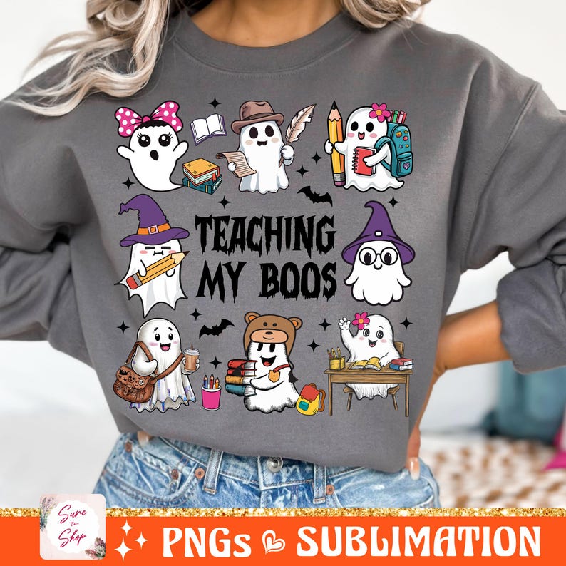 May include: A gray sweatshirt with a graphic of ghosts holding books and pencils. The text "TEACHING MY BOOS" is printed on the sweatshirt.
