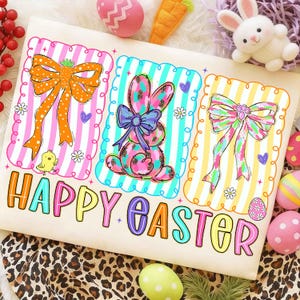 May include: A beige Easter-themed design featuring three framed illustrations of a bow, a bunny, and a bow. The illustrations are set against striped backgrounds in pink, blue, and yellow. The words "HAPPY EASTER" are written in colorful letters below the illustrations.