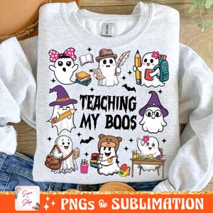May include: A gray sweatshirt with a design of ghosts dressed as teachers. The text "TEACHING MY BOOS" is printed on the sweatshirt.