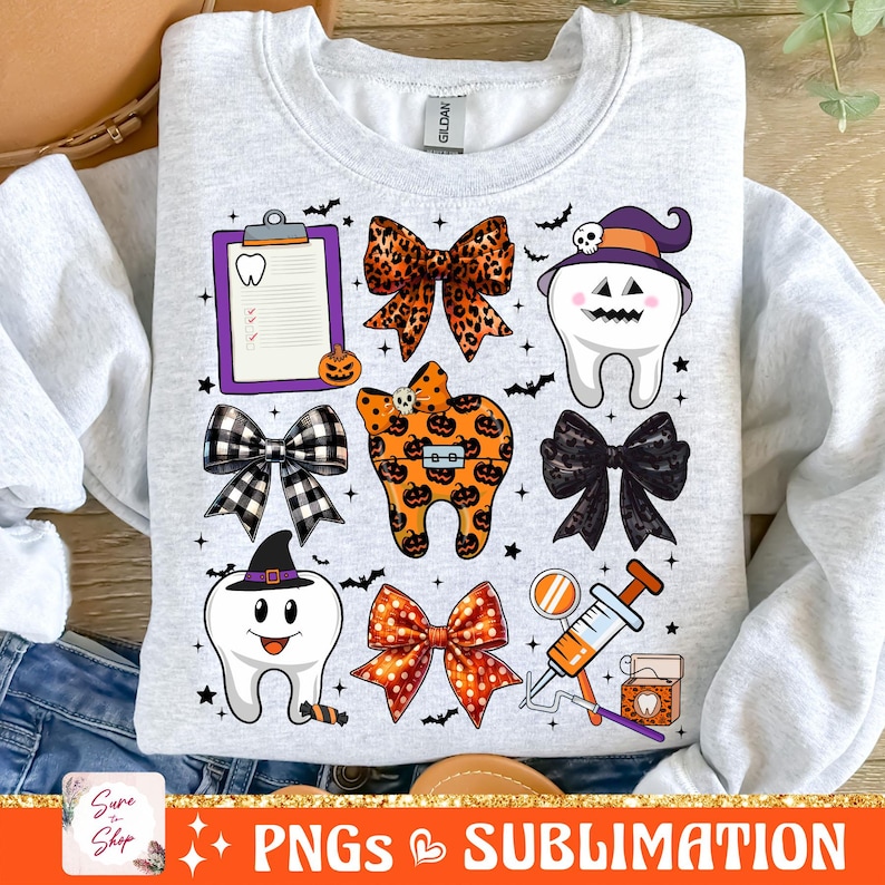 May include: A white sweatshirt with a Halloween-themed dental design. The design features a tooth with a witch's hat, a bow with orange and black polka dots, a tooth with a pumpkin design, a clipboard with a tooth icon, and a dental floss container.