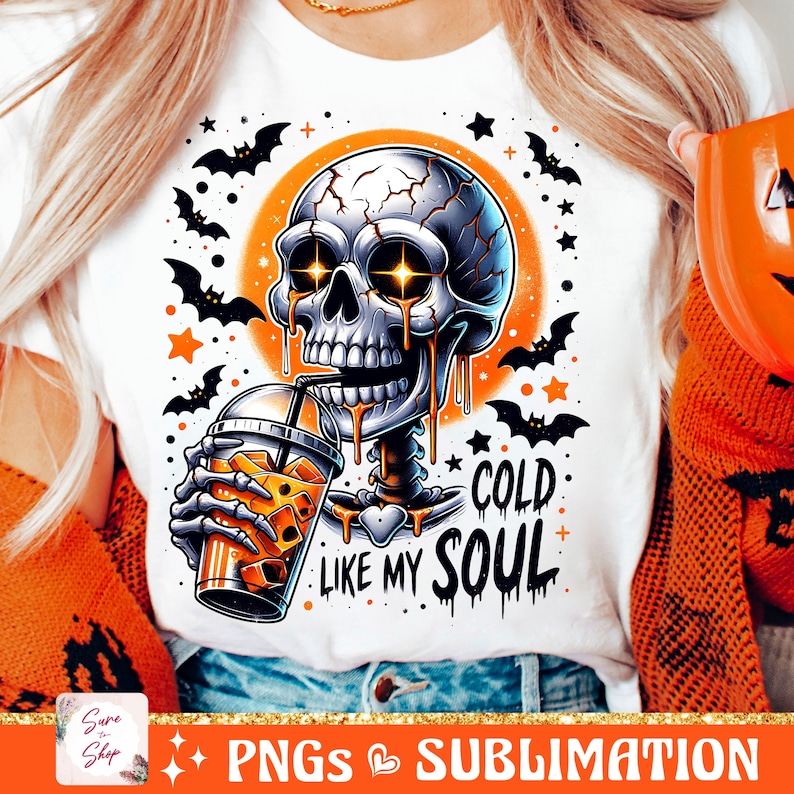May include: A white t-shirt with a graphic of a cartoon skeleton drinking a cold beverage. The skeleton is dripping orange liquid and has glowing eyes. The text "Cold Like My Soul" is printed below the skeleton.