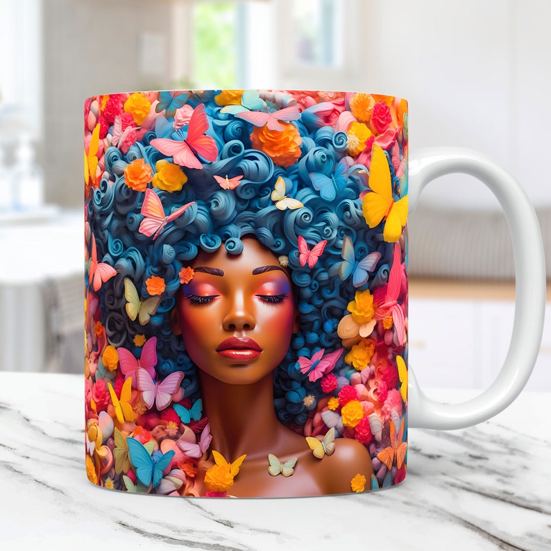 May include: A white ceramic mug with a colorful design featuring a woman with blue hair and butterflies. The woman has closed eyes and is surrounded by colorful flowers and butterflies.