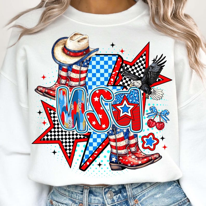 May include: White sweatshirt with a red, white, and blue graphic design featuring cowboy boots, a cowboy hat, an eagle, stars, and the word "USA".