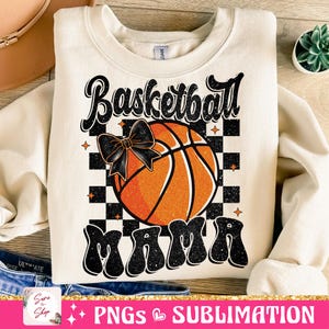 May include: A beige sweatshirt with a black and orange basketball graphic and the text "Basketball Mama" in black with a glittery effect.