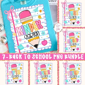 May include: A light blue t-shirt with a colorful graphic design featuring a pencil, apple, and the word "Kindergarten". The design is surrounded by a white scalloped border with pink bows and other school-themed elements. The image also shows designs for other grades.