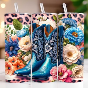 May include: A set of three 20 oz. stainless steel tumblers with a floral and cowboy boot design. The tumblers feature a pink leopard print background with a floral bouquet and a pair of blue cowboy boots.