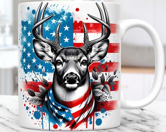 May include: White ceramic mug with a graphic of a deer wearing a red, white, and blue bandana with an American flag background. The deer is in the center of the mug and the flag is behind it. The flag is faded and has a watercolor effect. There are blue and red paint splatters on the mug.