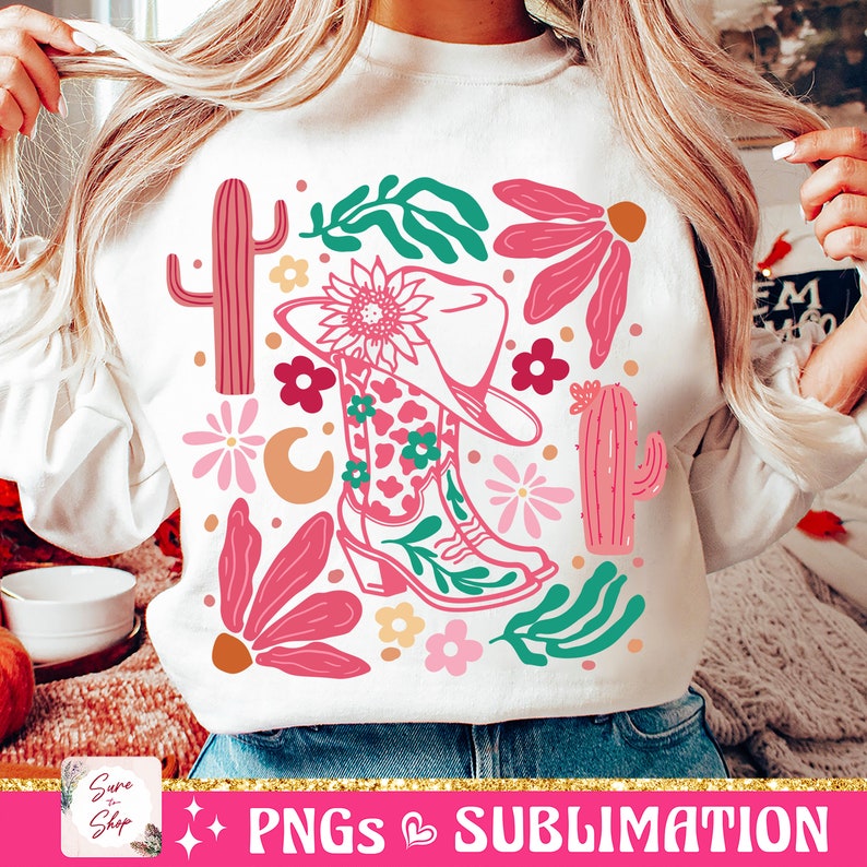 May include: White sweatshirt featuring a colorful western-themed design. The graphic includes a cowboy hat, boots, cacti, flowers, and the text "PNGs & Sublimation". The design incorporates pink, green, and orange elements.