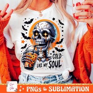 May include: A white t-shirt with a graphic of a skeleton drinking a cold beverage. The skeleton has glowing eyes and is dripping with a liquid that looks like honey. The text on the shirt reads "Cold Like My Soul".