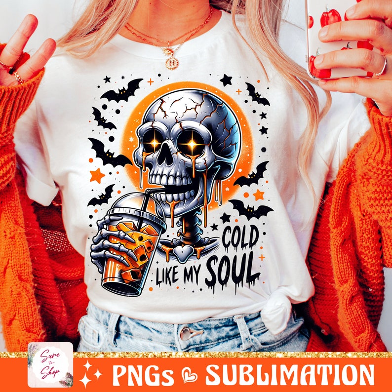 May include: A white t-shirt with a graphic of a skeleton drinking a cold beverage. The skeleton has glowing eyes and is dripping with a liquid that looks like honey. The text on the shirt reads "Cold Like My Soul".