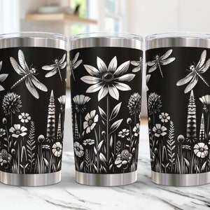 May include: Three stainless steel tumblers with a black background and a white floral and dragonfly design.