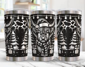 May include: Three stainless steel tumblers with a black and white design featuring a Highland cow wearing a Santa hat and scarf. The design also includes Christmas trees and lights.