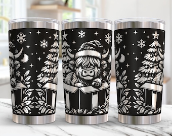 May include: Three black stainless steel tumblers with a white design of a Highland cow wearing a Santa hat and surrounded by Christmas trees and snowflakes.