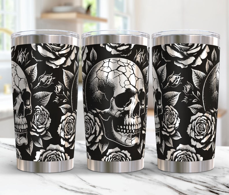 May include: Three stainless steel tumblers with a black and white skull and rose pattern. The tumblers are insulated and have a double-walled design.