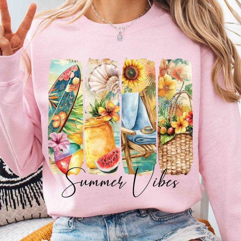 May include: Pink sweatshirt with a graphic design of a surfboard, seashells, sunflowers, a beach chair, and a basket of fruit. The text "Summer Vibes" is printed below the graphic.