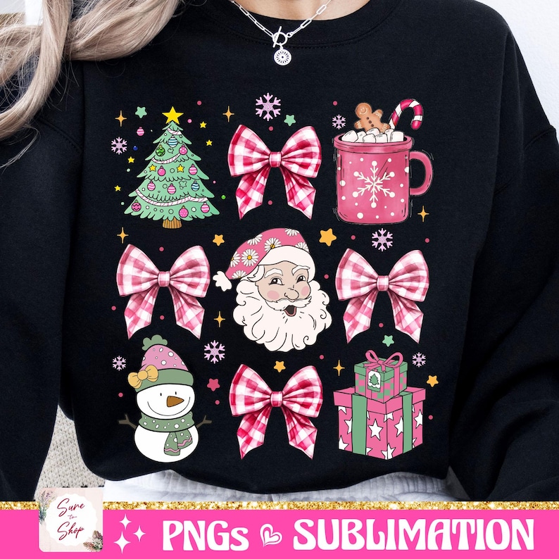May include: A black sweatshirt with a Christmas-themed design featuring a Christmas tree, Santa Claus, a snowman, a bow, a cup of hot chocolate, and a gift box. The design is in pink, green, and white.