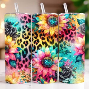 May include: Three stainless steel tumblers with lids and straws. Each tumbler features a different design with a colorful floral pattern, including sunflowers, roses, and leopard print. The background is a glittery turquoise and pink.