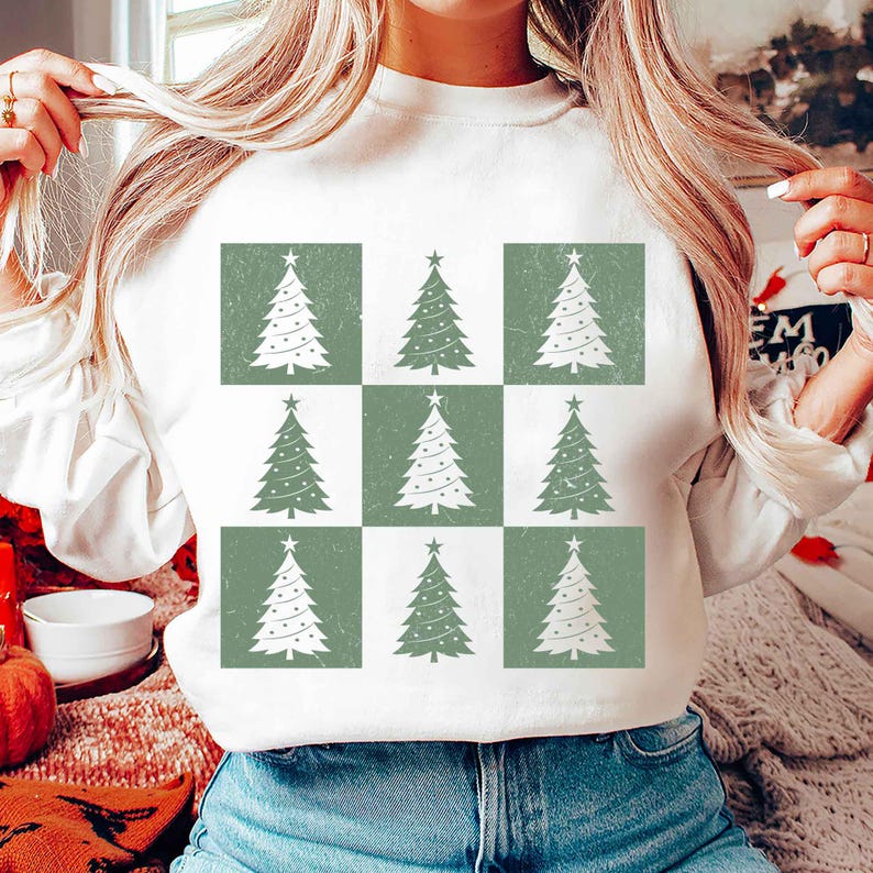 May include: White sweatshirt with a green and white checkered pattern featuring a repeating design of white Christmas trees with green ornaments.