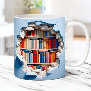 May include: A white ceramic mug with a blue background featuring a bookshelf filled with colorful books. The bookshelf appears to be inside a broken wall, creating a 3D effect.