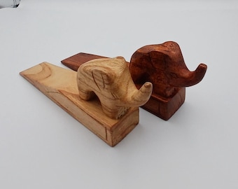 Handmade hardwood Door wedge with a cute carved Elephant sitting on top available in 2 colours. (17x6cm)