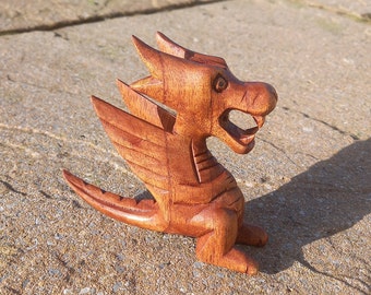 High quality Handcarved Wooden Dragon whos house trained and well fed stands 10cm tall from the tip of his tail to the top of his head