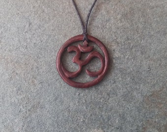 Beautifully handmade wooden Om pendant hung on a adjustable waxed cotton cord (4cm) Exquisite detail and fine finish.
