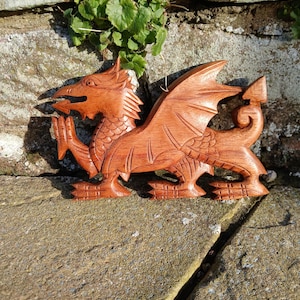 Hand carved Dragon plynth that has been coloured and polished to a wonderfully smooth finish with dark beeswax. (25x15cm)
