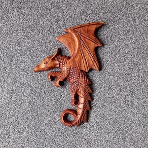 Hand carved Dragon plynth that has been coloured and polished to a wonderfully smooth finish with dark beeswax.