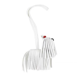 May include: White leather dog keychain with a long, flowing tail and a red bead for a nose.