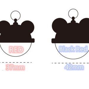 May include: Two black and white mouse-shaped keychains with red and blue text. The keychain on the left is 37mm and says "RED". The keychain on the right is 42mm and says "Black Red".