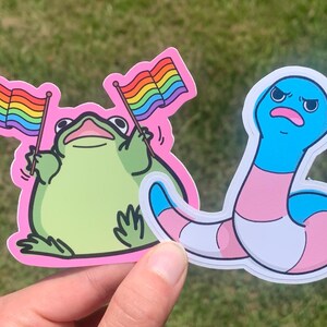 2 Pack Gay Trans Pride Stickers / Cute Funny Transbian Gift for Queer Transgender Month Frog Waving Rainbow Flag Sassy Worm Cartoon Drawing