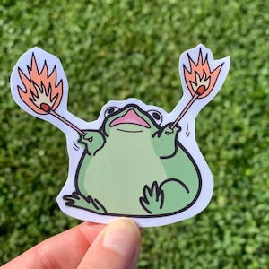 Pegatina de rana caótica agitando cerillas / Linda y divertida calcomanía de dibujos animados kawaii de pirómano tonto, incendiario, incendio provocado para adolescentes, botella de agua, computadora portátil