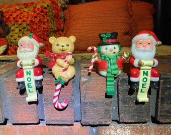 Set of four vintage stocking hangers.