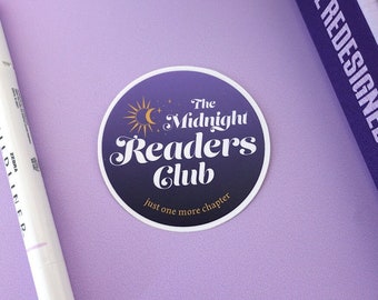 May include: A purple and gold round sticker with the text "The Midnight Readers Club" and the words "just one more chapter" below. The sticker features a crescent moon and a sun.