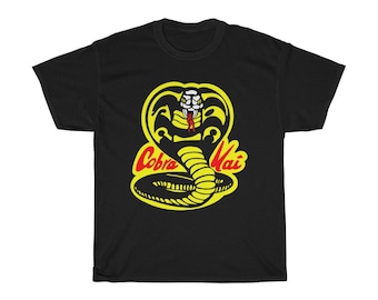 May include: Black t-shirt with a yellow cobra graphic and the text "Cobra Kai" in red.