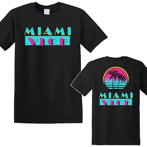 May include: Two black t-shirts with the text "Miami Vice" in pink, blue, and yellow. One shirt features a palm tree graphic with a sunset.