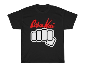 May include: Black t-shirt with a white fist and the words "Cobra Kai" in red.