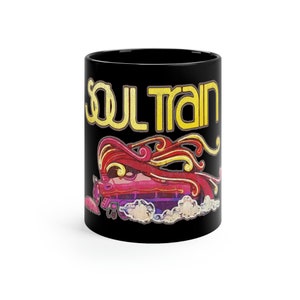May include: Black ceramic mug with a colorful graphic of a train with the text "Soul Train" in yellow.